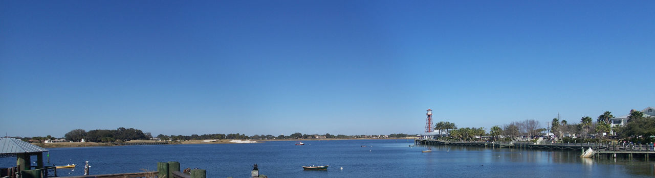 Waterfront scene with boats and lighthouse